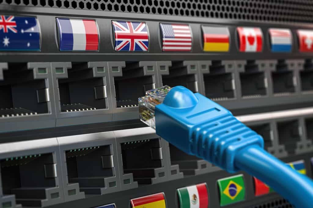 A blue ethernet cable is connected to a server in a business environment with various flags.