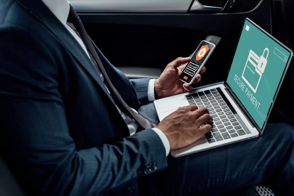 Businessman using computer and mobile device security